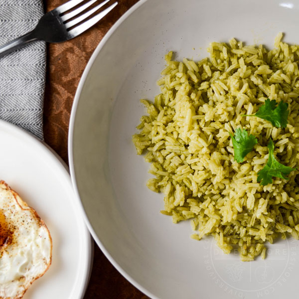 Arroz verde (Mexican green rice) in a bowl, topped with cilantro