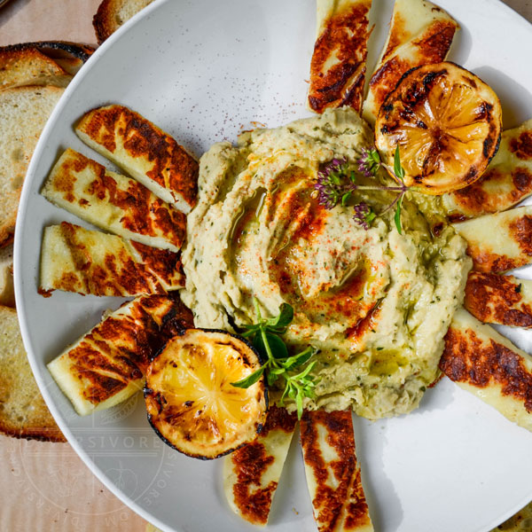 Grilled Halloumi with basil-cannellini hummus, served with grilled lemons and toasted baguette