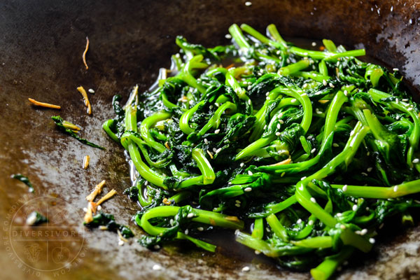 Honey and ginger pea tips in a steel wok
