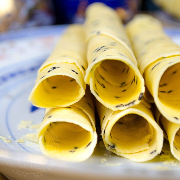 Chinese Crispy Egg Roll (Biscuit Roll) Cookies on a patterned Chinese plate