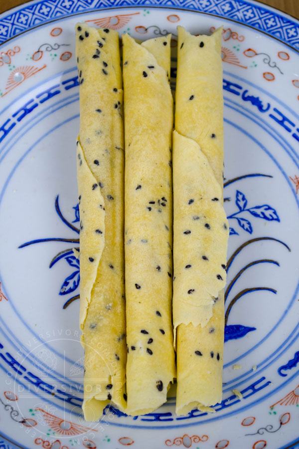 Chinese Crispy Egg Roll (Biscuit Roll) Cookies on a patterned Chinese plate