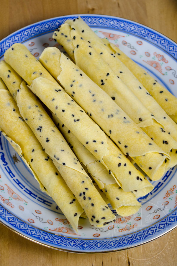 Chinese Crispy Egg Roll (Biscuit Roll) Cookies on a patterned Chinese plate