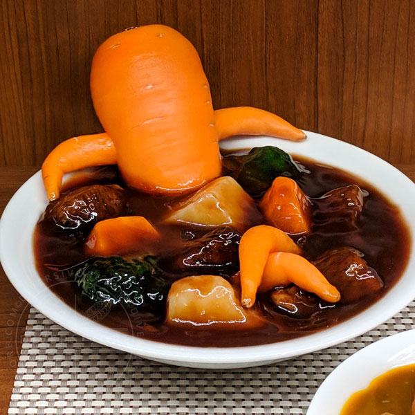 A very relaxed looking carrot in a stew from a replica food store in Tokyo