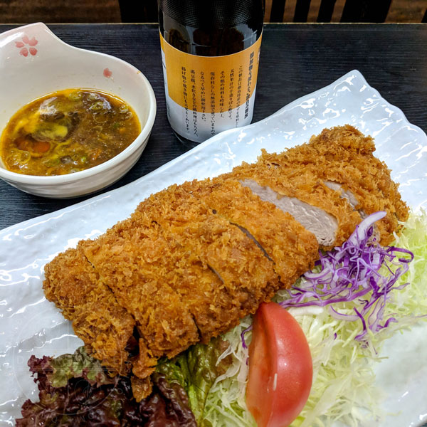 Tonkatsu served with ponzu and raw egg at a restaurant in Osaka
