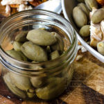 Pickled fresh green almonds, served here with roasted chicken - Diversivore.com