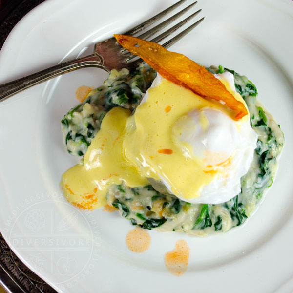 Eggs Sardou - A poached egg served over an artichoke bottom and creamed spinach, smothered in hollandaise sauce.