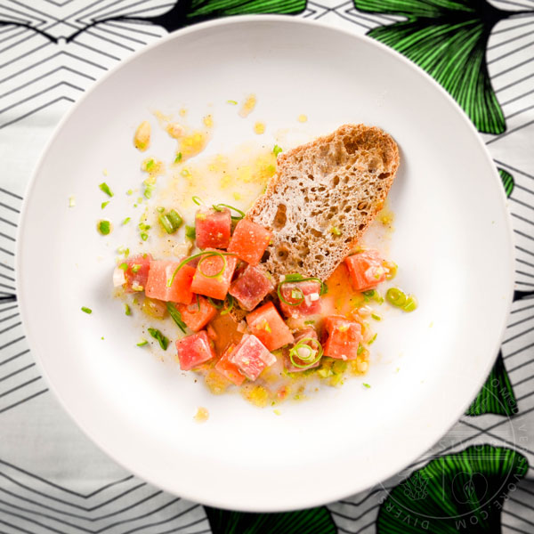 Watermelon and Ahi Tuna Crudo on a plate with bread