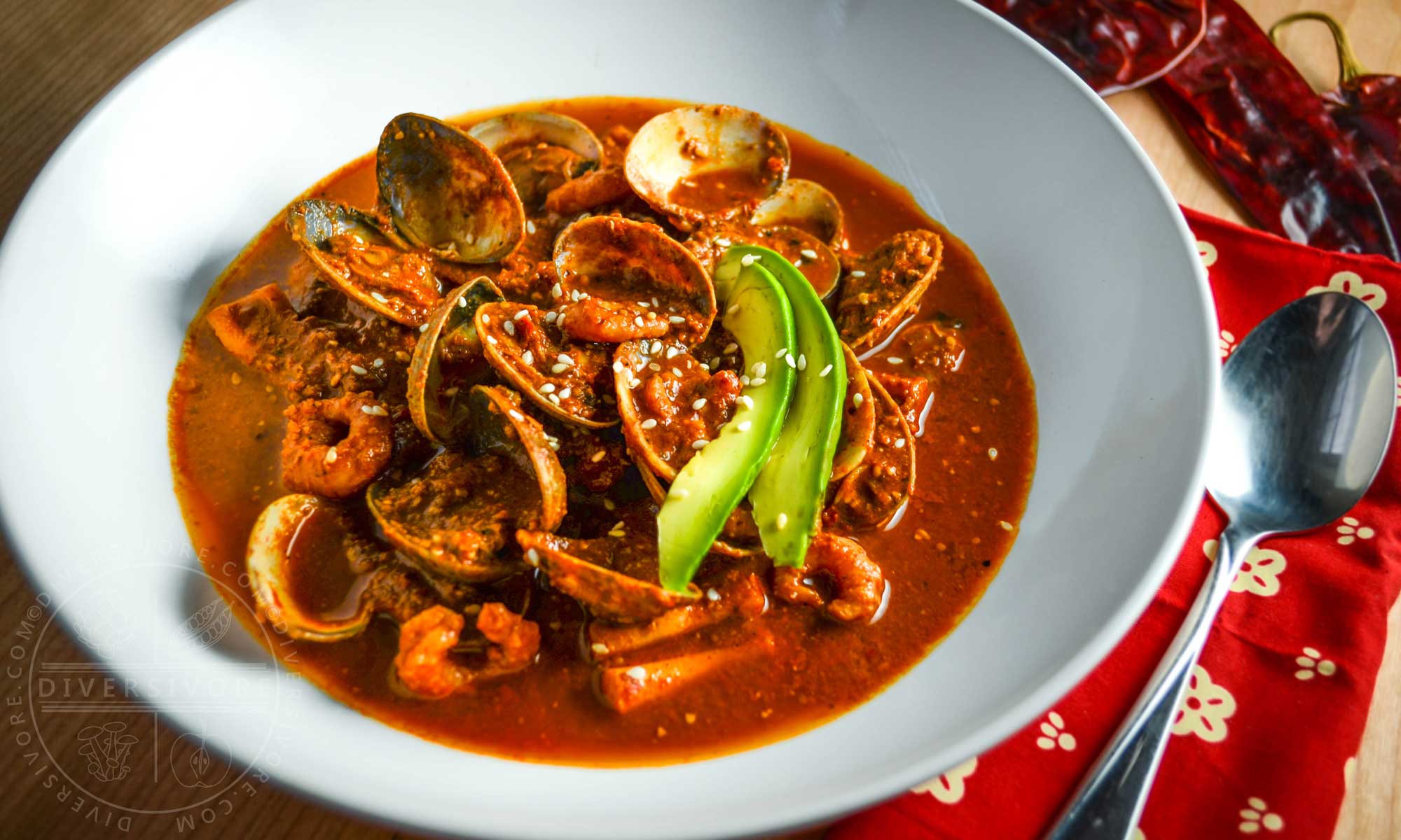 Red Pipian Seafood Soup, garnished with fresh avocado