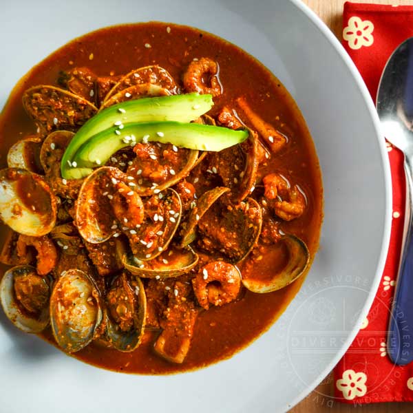 Red Pipian Seafood Soup, garnished with fresh avocado