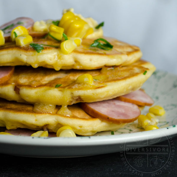 Savory pancakes with corn and kielbasa on floral patterned plate