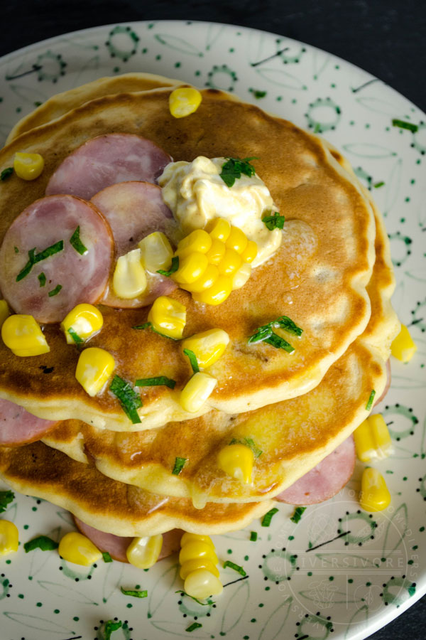 Savory pancakes with corn and kielbasa on floral patterned plate