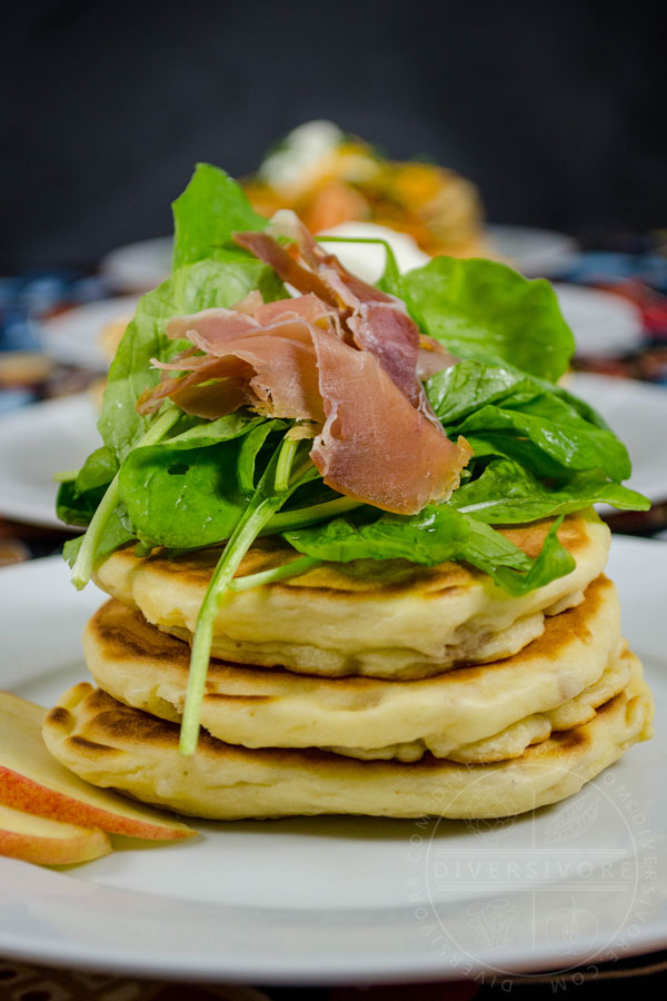 Prosciutto, apple, and arugula pancakes in front of several other savory pancake variations