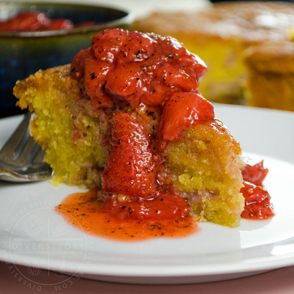 Strawberry polenta cake with strawberry and black pepper compote served on a white plate with a silver fork
