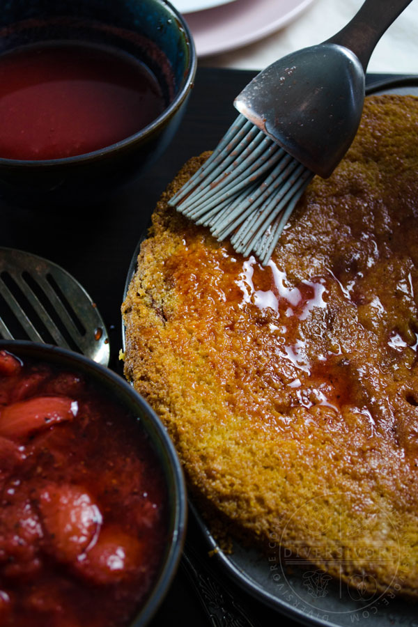 Brushing syrup on a strawberry polenta, flanked by strawberry black pepper compote and sauce.