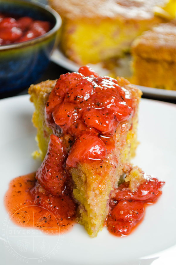 Strawberry polenta cake with strawberry and black pepper compote served on a white plate
