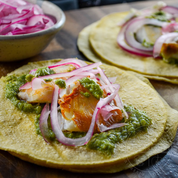 Fish tacos with cilantro corn salsa and pickled red onions