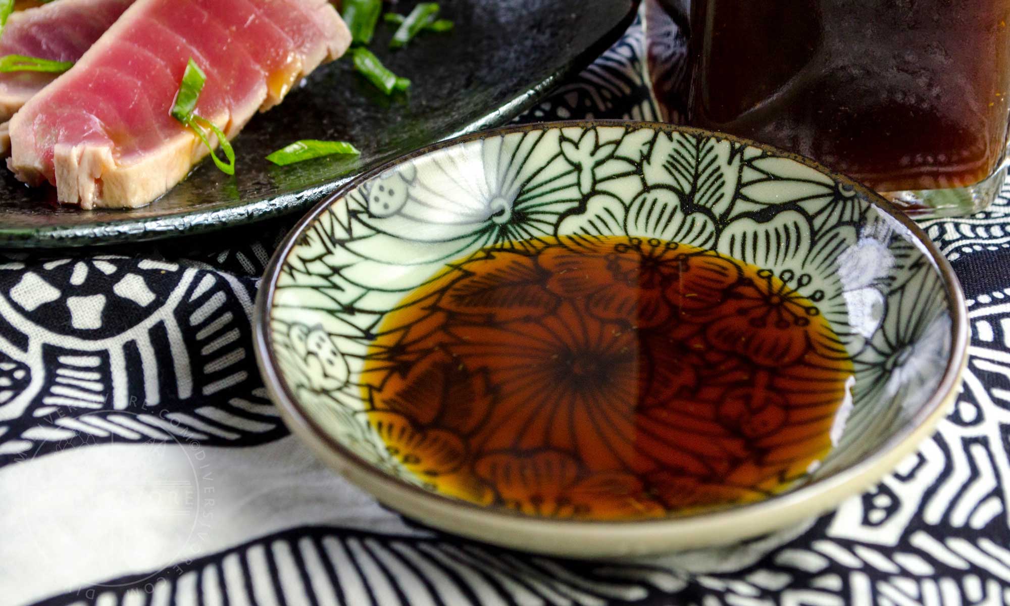 Ponzu shoyu in a small dish beside seared tuna tataki