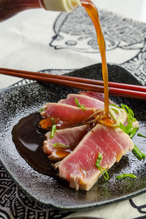 Ponzu shoyu being poured onto tuna tataki in a small dish