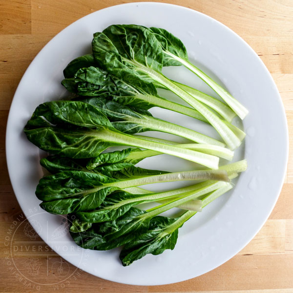 Tatsoi (Rosette Bok Choy) leaves spread out on a white plate