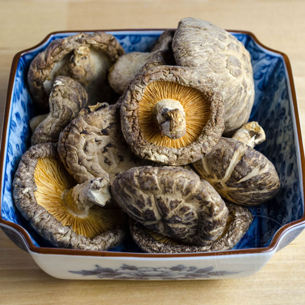 Dried shiitake mushrooms in a small blue dish