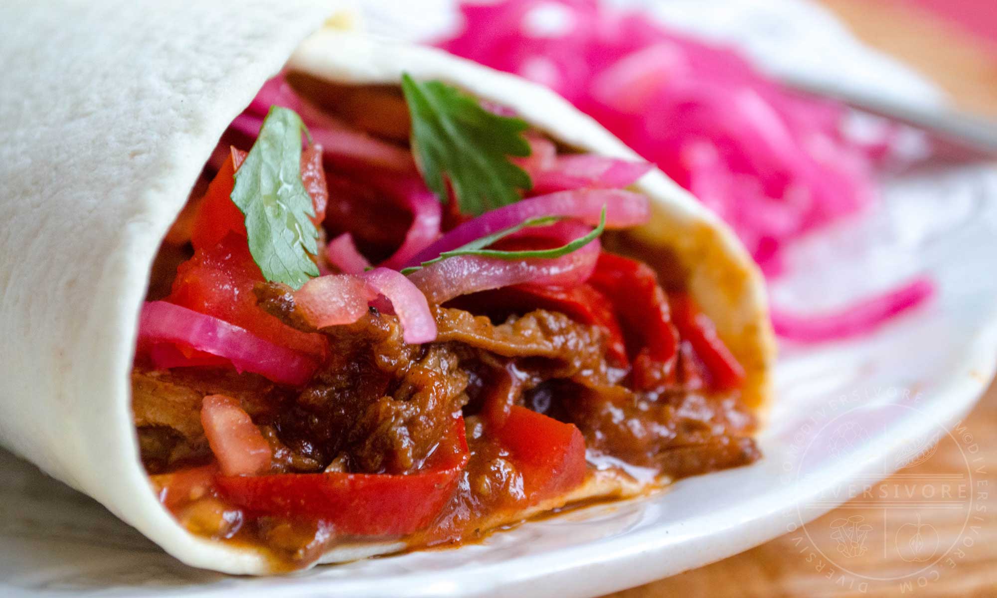 Carne Entomatada - beef in a Mexican-spiced tomato sauce, served here in a flour tortilla shell