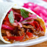 Carne Entomatada - beef in a Mexican-spiced tomato sauce, served here in a flour tortilla shell - Diversivore.com