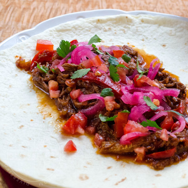 Carne Entomatada - beef in a Mexican-spiced tomato sauce, served here in an open flour tortilla shell
