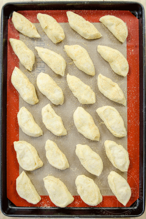 Pandesal on a baking tray, animated to show the proofing stage and the finished baked product