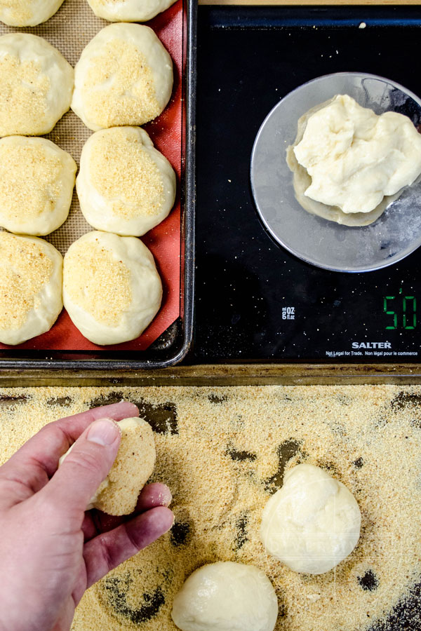 Weigh and shaping pandesal before dipping them in breadcrumbs