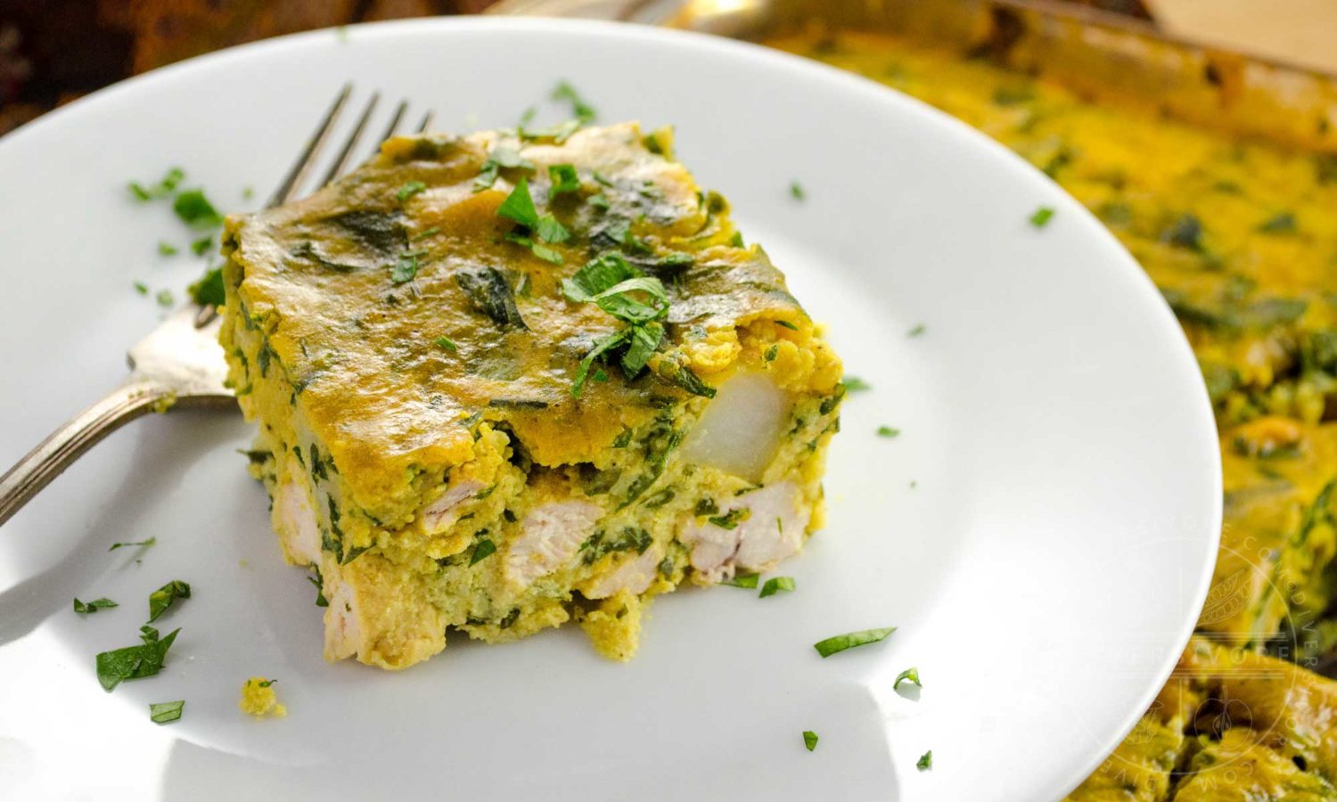 Tajine Maadnous (Tunisian egg and chicken tajine) served on a white plate