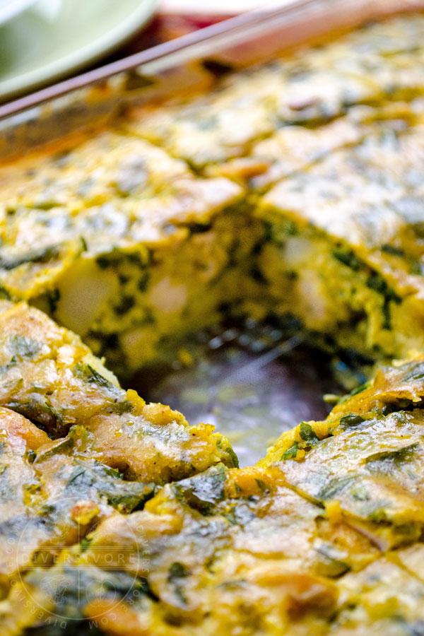 Tajine Maadnous (Tunisian egg and chicken tajine/frittata) with a portion removed