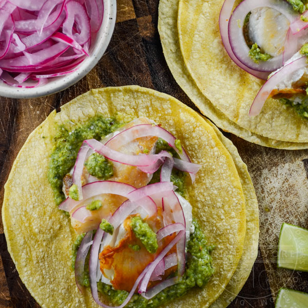 Fish tacos with cilantro corn salsa and pickled red onions