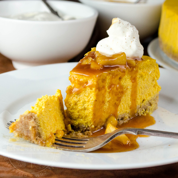 Pumpkin apple cheesecake with apple caramel sauce, whipped cream, and a gluten-free oat crust