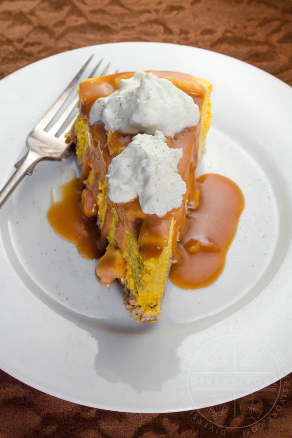 Pumpkin apple cheesecake with apple caramel sauce, whipped cream, and a gluten-free oat crust
