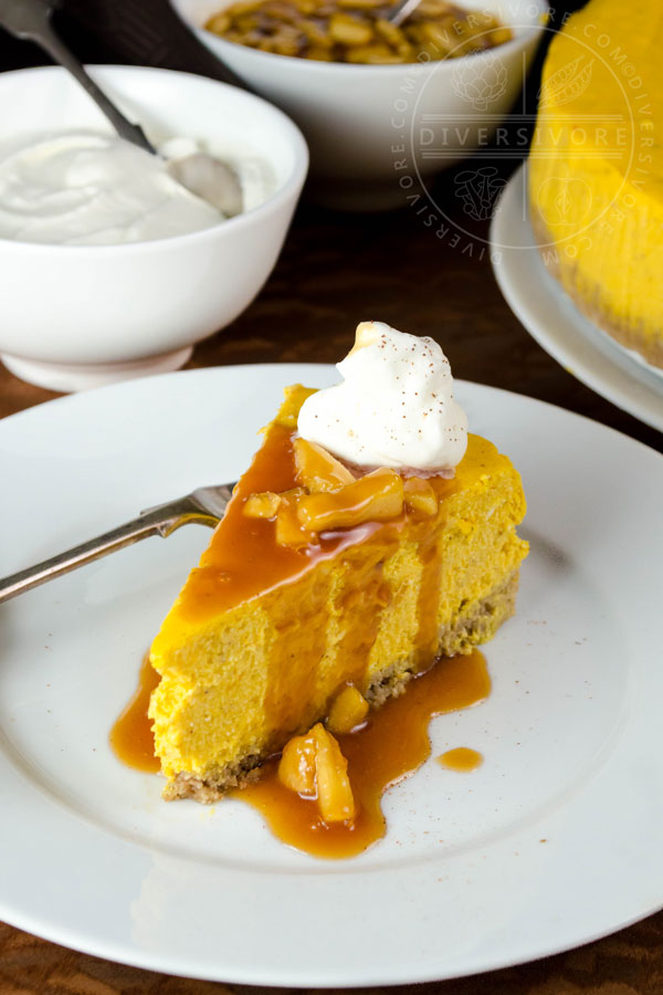 Pumpkin apple cheesecake with apple caramel sauce, whipped cream, and a gluten-free oat crust