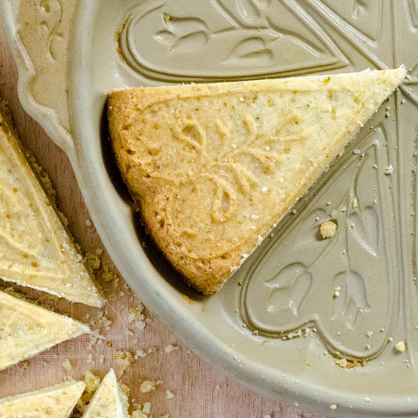 A wedge of shortbread in a ceramic baking dish