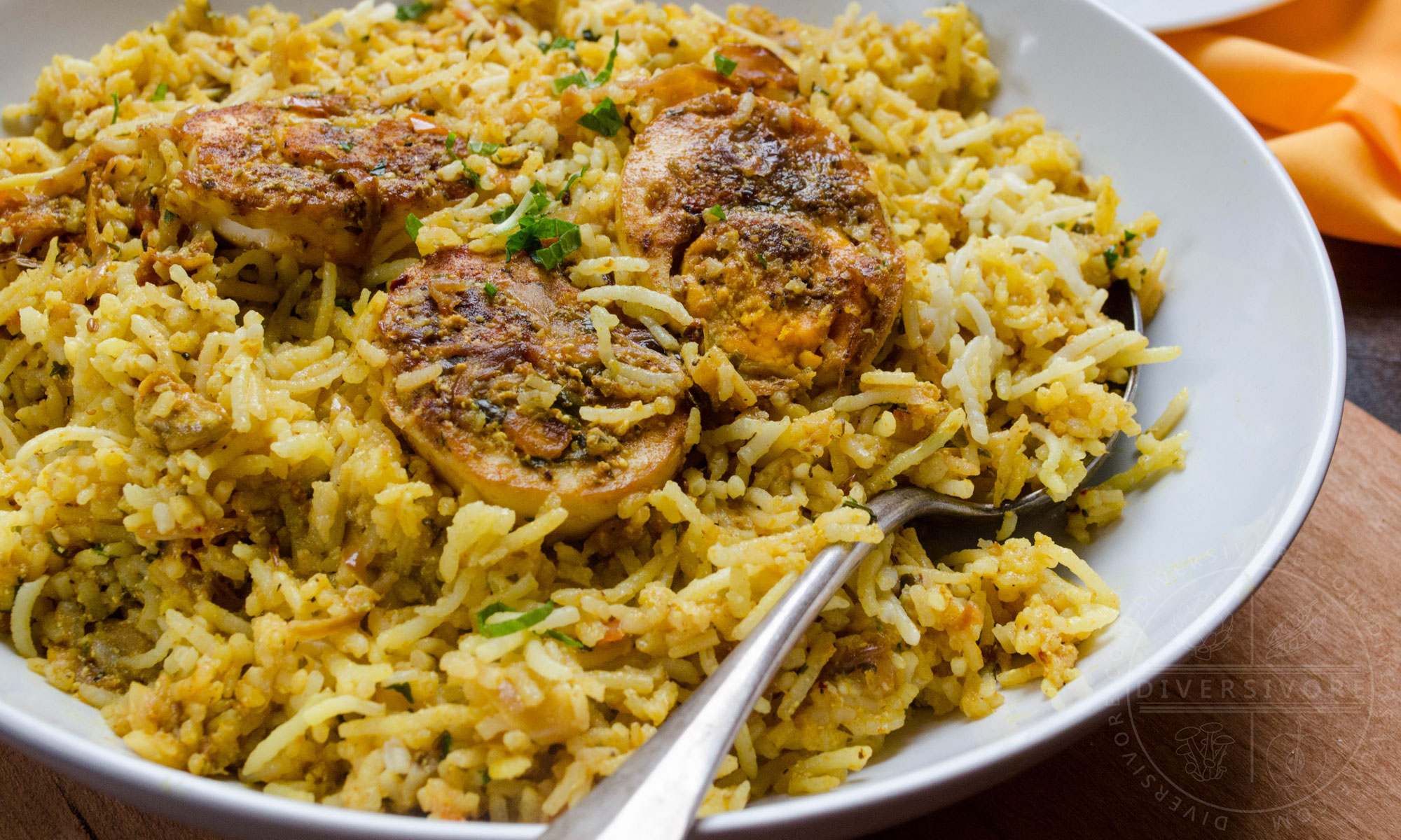 Hyderabadi egg biryani in a large white serving bowl