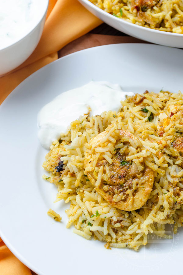 Hyderabadi egg biryani on a plate with cucumber raita