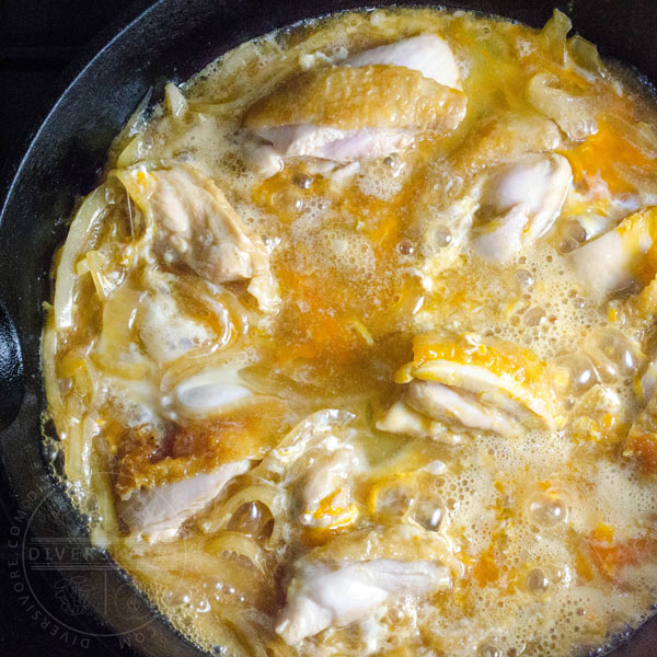 Oyakodon cooking in a skillet, immediately after adding eggs