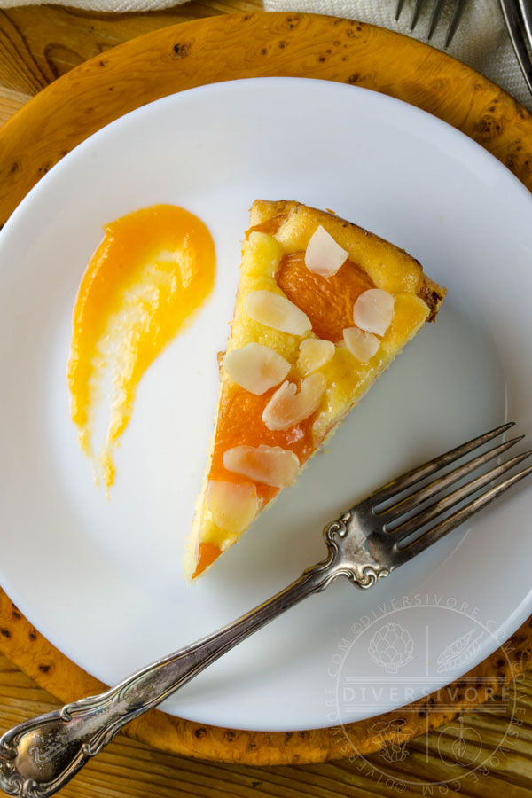 A slice of Aprikosenkuchen (German Apricot Cake) on a plate with apricot puree