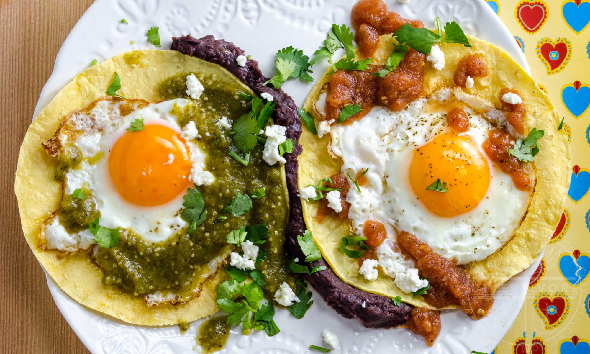 Huevos divorciados - fried eggs served with tortillas and two kinds of  salsa