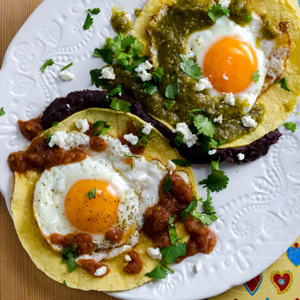 Huevos Divorciados - divorced eggs - served with tortillas, refried beans, and two kinds of salsa