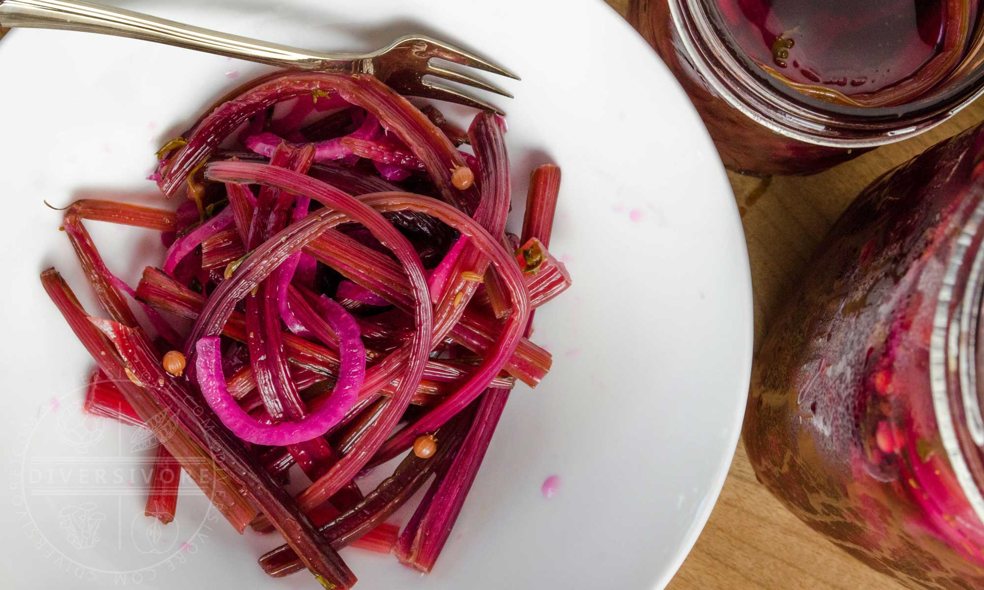 Spicy beet stem pickles in a white bowl