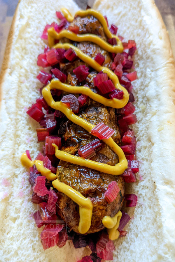 Spicy pickled beet stems diced and served with mustard on a sausage