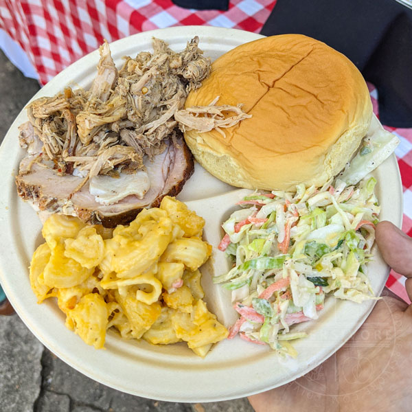 A plate of BBQ pork, turkey, and sides from pitmaster Rodney Scott