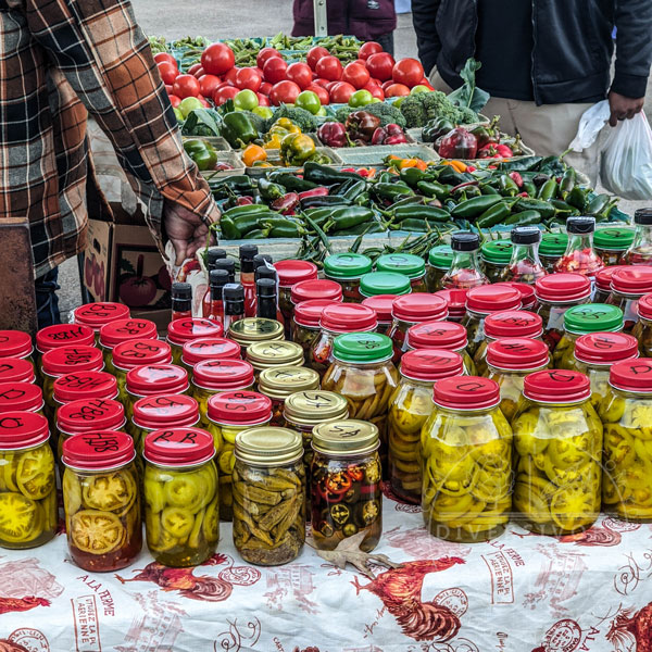 Produce and various pickles being sold at the Pepper Place Farmer's Market in Birmingham, Alabama