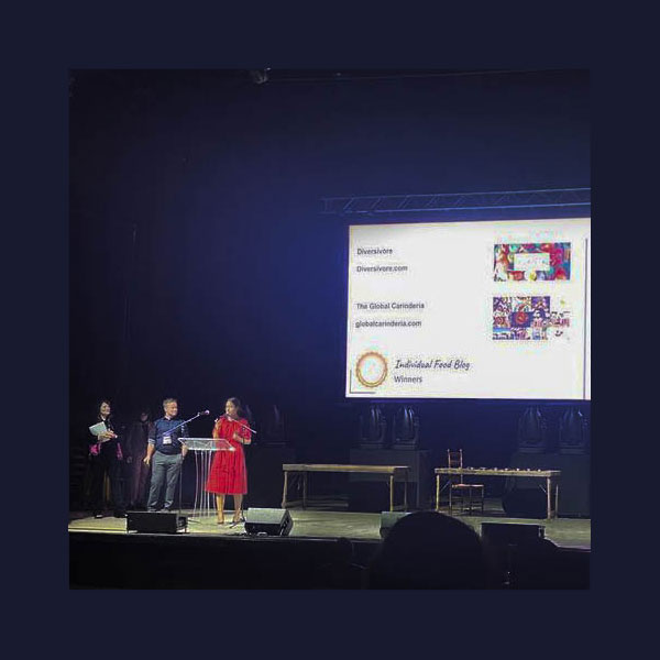 Sean Bromilow of Diversivore and Jennifer Fergesen of Global Carinderia - co-winners of the 2021 IACP Award for best individual food blog accepting their awards on stage