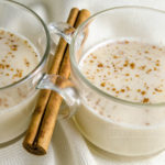 Coquito - Puerto Rican Eggnog - served in glass mugs with a cinnamon stick