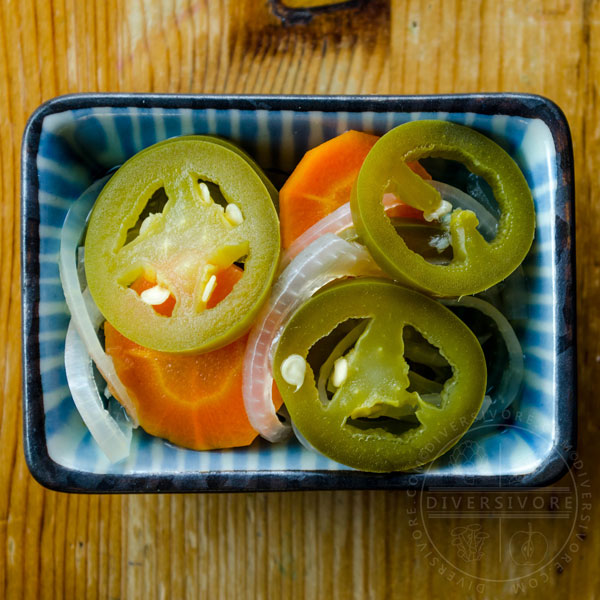 Chiles en escabeche - Mexican pickled carrots and jalapeños in a small dish