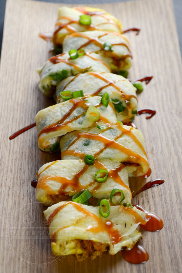 Dan bing (Taiwanese egg crepe) sliced and drizzled with chili sauce and Taiwanese soy sauce